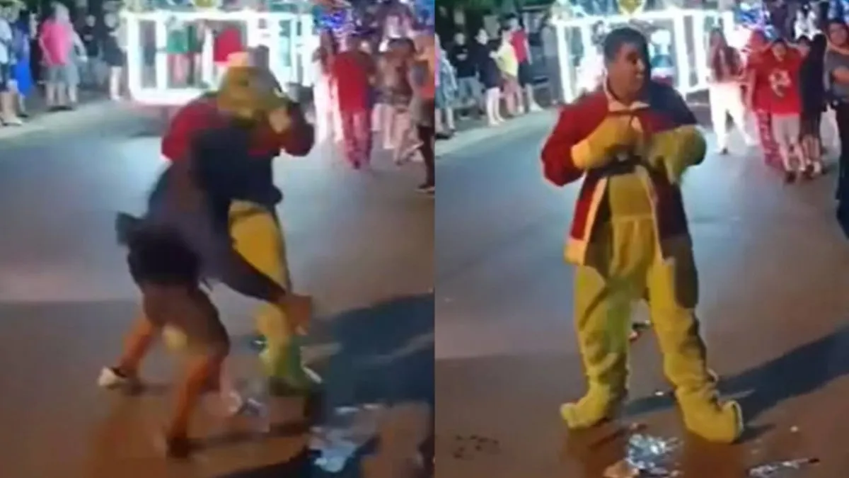 Un carabinero disfrazado de Grinch defiende a "Viejita Pascuera" de un acosador.